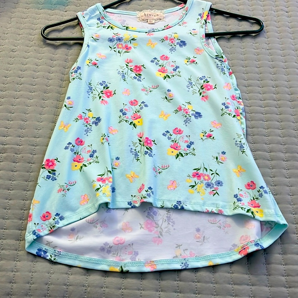 Thai is an ocean blue tank only wore 1 time and can be designed different ways.